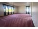Large bonus room with carpeted floor is flooded with natural light from large bright windows at 7611 Avila Beach Ave, Las Vegas, NV 89113