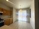 Cozy dining area with tile flooring, sliding glass door to the backyard, and light wood cabinets at 7611 Avila Beach Ave, Las Vegas, NV 89113