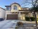 Charming two-story home featuring a two-car garage and desert landscaping in a residential neighborhood at 7611 Avila Beach Ave, Las Vegas, NV 89113