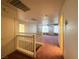 Upstairs hallway features a white bannister, plush carpet, and access to the bedrooms at 7611 Avila Beach Ave, Las Vegas, NV 89113