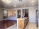 Modern kitchen with an island, tile floors, stainless steel appliances and a seamless flow to the living area at 7611 Avila Beach Ave, Las Vegas, NV 89113