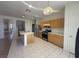 Functional kitchen featuring an island, stainless steel appliances, tile flooring, and wood cabinetry at 7611 Avila Beach Ave, Las Vegas, NV 89113