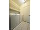 Convenient laundry room features tile floors, door to outside, and stacked storage shelving at 7611 Avila Beach Ave, Las Vegas, NV 89113