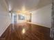 Bright and spacious living room featuring hardwood floors, neutral walls, and a decorative room divider at 7611 Avila Beach Ave, Las Vegas, NV 89113