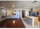 Open-concept living space seamlessly connects to the kitchen, showcasing hardwood floors and ample natural light at 7611 Avila Beach Ave, Las Vegas, NV 89113