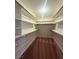 This walk-in closet provides ample storage space with shelving and hanging racks at 7611 Avila Beach Ave, Las Vegas, NV 89113