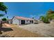 Backyard of house with red tile roofing, desert landscaping, and partial shade at 7898 Rye Canyon Dr, Las Vegas, NV 89123