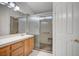 Bathroom boasting modern shower, hand rails, white tiled floors and sleek fixtures at 7898 Rye Canyon Dr, Las Vegas, NV 89123