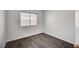 Bedroom with a window offering natural light and dark hardwood flooring at 7898 Rye Canyon Dr, Las Vegas, NV 89123