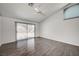 Bright bedroom with hardwood floors, sliding glass door and ceiling fan at 7898 Rye Canyon Dr, Las Vegas, NV 89123