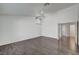 Bright bedroom with hardwood floors, ceiling fan and doorway access to another room at 7898 Rye Canyon Dr, Las Vegas, NV 89123