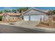 Charming single-story home with a two-car garage, desert landscaping, and a tile roof at 7898 Rye Canyon Dr, Las Vegas, NV 89123