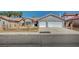 Charming single-story home with a two-car garage, desert landscaping, and a tile roof at 7898 Rye Canyon Dr, Las Vegas, NV 89123