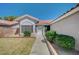 Inviting front entrance with well-maintained landscaping and a light-colored facade at 7898 Rye Canyon Dr, Las Vegas, NV 89123