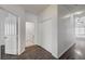 Hallway with dark hardwood floors and white doors that enhance the bright space at 7898 Rye Canyon Dr, Las Vegas, NV 89123
