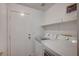 Laundry room with white washer and dryer set and a door to the outside at 7898 Rye Canyon Dr, Las Vegas, NV 89123