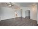 Open living room with hardwood floors, neutral paint, and access to other rooms at 7898 Rye Canyon Dr, Las Vegas, NV 89123