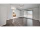 Hardwood-floored bedroom with ensuite access, window, and vaulted ceiling at 7898 Rye Canyon Dr, Las Vegas, NV 89123