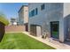 Private backyard with lush artificial turf and a convenient storage shed at 8125 Monsoon Bay St, Las Vegas, NV 89113