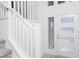 Bright entryway featuring a modern door with glass panes, white railing, and carpeted stairs at 8125 Monsoon Bay St, Las Vegas, NV 89113