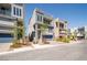 View of modern home with desert landscaping, two-car garage, and balcony at 8125 Monsoon Bay St, Las Vegas, NV 89113