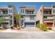 Contemporary two-story home featuring a two-car garage, balcony, modern design, and desert landscaping at 8125 Monsoon Bay St, Las Vegas, NV 89113