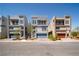 View of three modern homes with 2 stories, desert landscaping, and balconies at 8125 Monsoon Bay St, Las Vegas, NV 89113