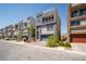Street view of modern townhomes with desert landscaping and two-car garages at 8125 Monsoon Bay St, Las Vegas, NV 89113