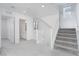 Bright hallway with staircase and access to a bathroom with white fixtures at 8125 Monsoon Bay St, Las Vegas, NV 89113