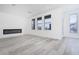 Modern living room with a fireplace, recessed lighting, and large windows at 8125 Monsoon Bay St, Las Vegas, NV 89113