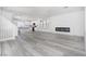 Open-concept living room with fireplace, hardwood floors, and modern design at 8125 Monsoon Bay St, Las Vegas, NV 89113