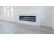 Sleek electric fireplace adds modern design against the light gray flooring at 8125 Monsoon Bay St, Las Vegas, NV 89113