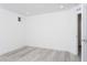 Bright and airy room with gray wood-look floors and a small window at 8125 Monsoon Bay St, Las Vegas, NV 89113
