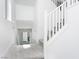 Bright staircase featuring white railings, carpeted stairs, and access to the lower level at 8125 Monsoon Bay St, Las Vegas, NV 89113