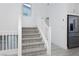 Bright staircase with white banister and carpeted steps leads to the upper level at 8125 Monsoon Bay St, Las Vegas, NV 89113