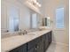 A sleek bathroom with a double sink vanity, a large mirror, and modern fixtures for added convenience at 8732 Kendall Brook Cir, Las Vegas, NV 89149