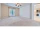 Bright, spacious carpeted bedroom with ceiling fan and patio doors leading to outdoor space at 8732 Kendall Brook Cir, Las Vegas, NV 89149
