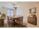 Formal dining room with rustic wooden table, seating for ten, and decorative wall trim and furnishings at 8732 Kendall Brook Cir, Las Vegas, NV 89149