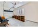 An organized garage space with epoxy floors, storage shelves, and a large door for easy access at 8732 Kendall Brook Cir, Las Vegas, NV 89149