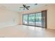 Open living room with sliding glass doors and tiled flooring, ready for personalization at 8732 Kendall Brook Cir, Las Vegas, NV 89149