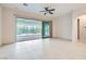 Bright living room with sliding glass doors and tiled flooring, leading to backyard at 8732 Kendall Brook Cir, Las Vegas, NV 89149