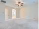Large carpeted main bedroom showing bathroom entrance, ceiling fan and neutral decor at 8732 Kendall Brook Cir, Las Vegas, NV 89149