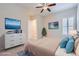 Staged main bedroom with a dresser, two wall decor, and shuttered windows at 8732 Kendall Brook Cir, Las Vegas, NV 89149