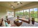 Relaxing sunroom with ample seating, brick floors, many windows, and serene views of the outdoors at 8732 Kendall Brook Cir, Las Vegas, NV 89149