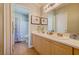 Well-appointed bathroom featuring a double vanity, tile floors and a separate area for the toilet and shower at 8811 Tomnitz Ave # 101, Las Vegas, NV 89178