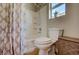 Clean and functional bathroom features a shower-tub combo with decorative curtain and ample storage for toiletries at 8811 Tomnitz Ave # 101, Las Vegas, NV 89178