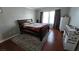 Bright bedroom with hardwood floors, a comfortable bed, dresser, and a serene atmosphere for relaxation at 8811 Tomnitz Ave # 101, Las Vegas, NV 89178