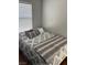 Cozy bedroom showcasing a plush bed with decorative pillows and soft, neutral tones at 8811 Tomnitz Ave # 101, Las Vegas, NV 89178
