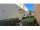 Side view of townhouse showcasing manicured bushes and dual entryways with covered porticos for added protection at 8811 Tomnitz Ave # 101, Las Vegas, NV 89178