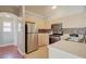 Well-lit kitchen features neutral cabinets, stainless steel appliances and a tile backsplash with a stainless sink at 8811 Tomnitz Ave # 101, Las Vegas, NV 89178